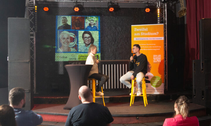 Die Moderatorin sitzt mit ihrem Gast auf der Bühne.